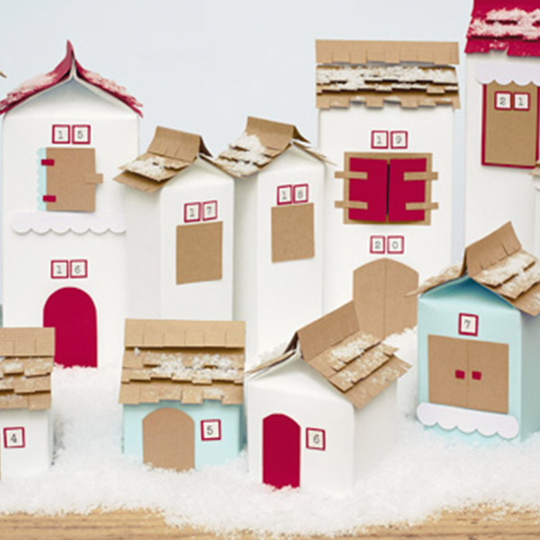Christmas village DIY advent calendar with dates on houses in the village.