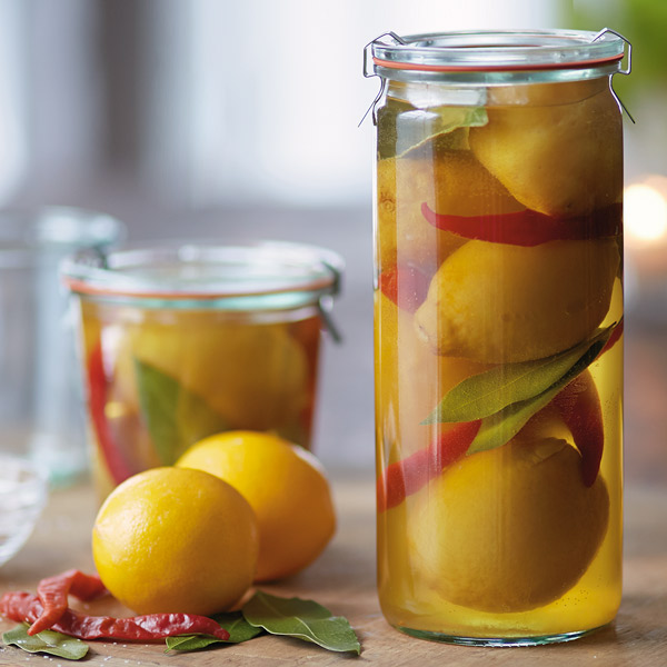 Jars of preserved lemons in a solution of salt and lemon juice.