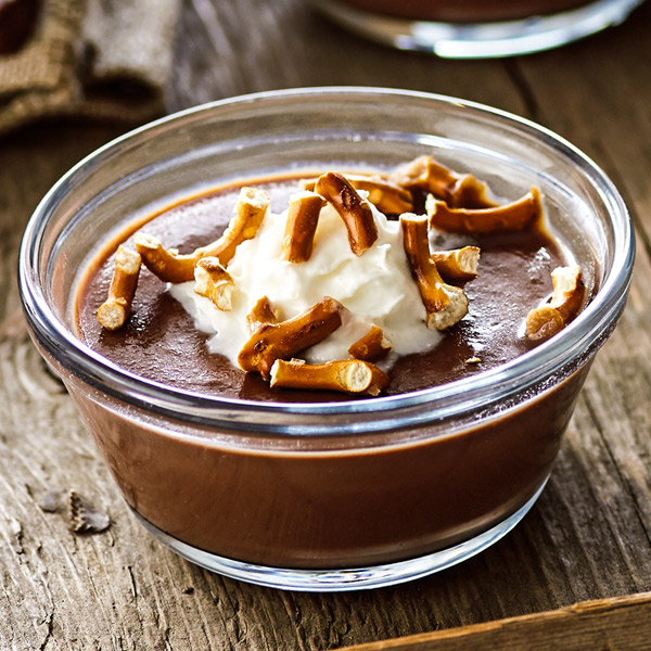 Chocolate stout pudding with whipped cream and pretzel bits.
