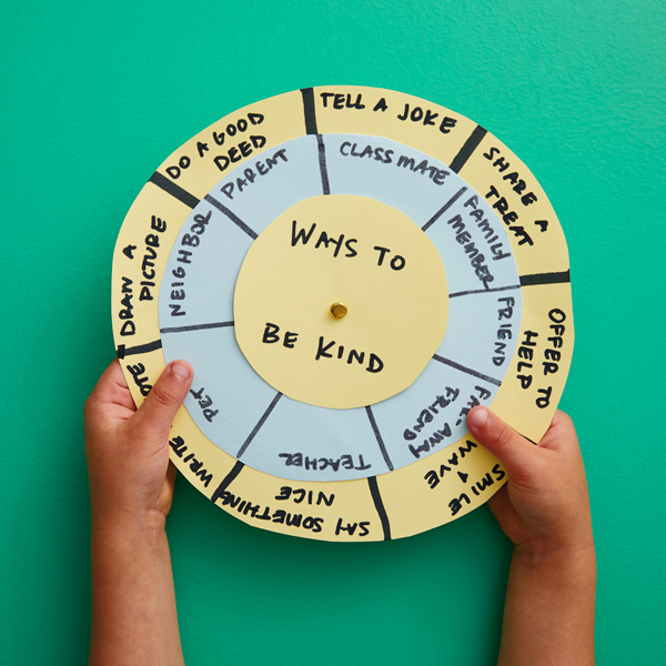 Kids' hands holding activity spinner