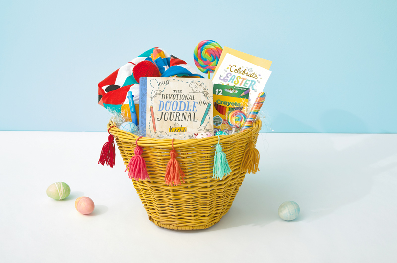 A kids' themed Easter care package with a devotional doodle journal, Crayola markers, candy and a card.