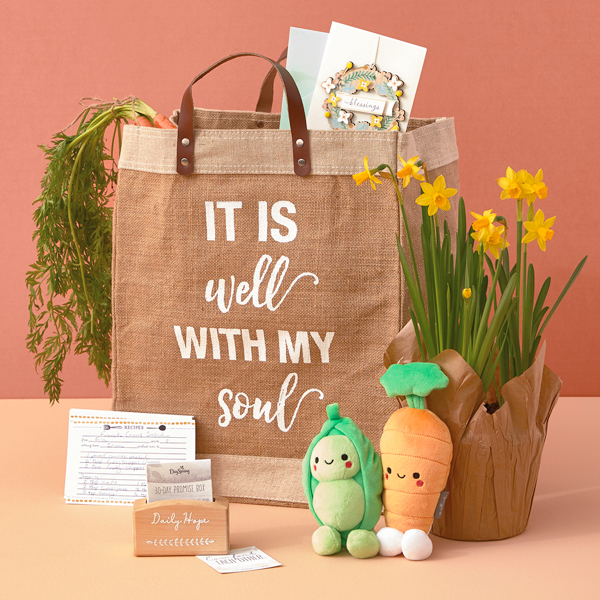 A farmer's market themed Easter care package with a pea and carrot Better Together plush set, potted narcissus flowers, a tote bag that reads,