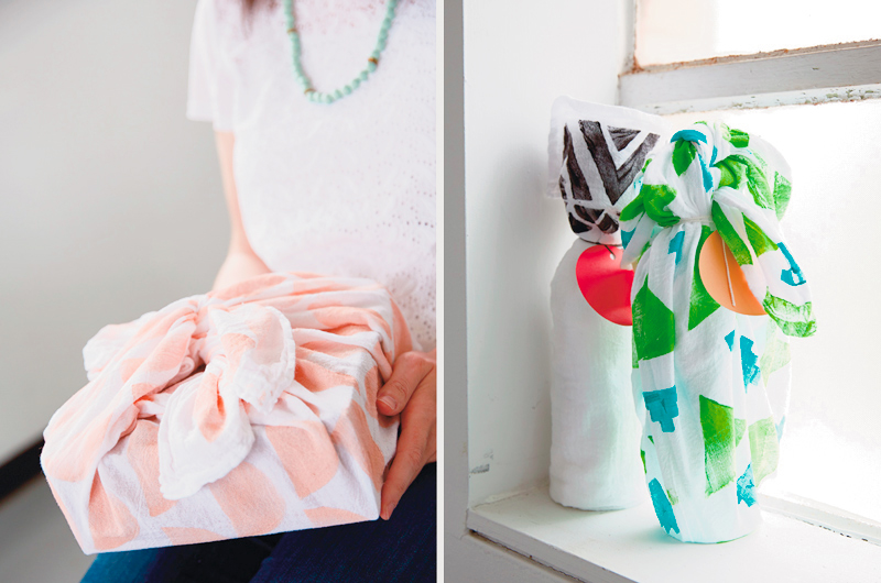 Two examples of using tea towels to wrap gifts—one a simple box with the corners tied on top, the other a bottle with the corners tied around the neck of the bottle.