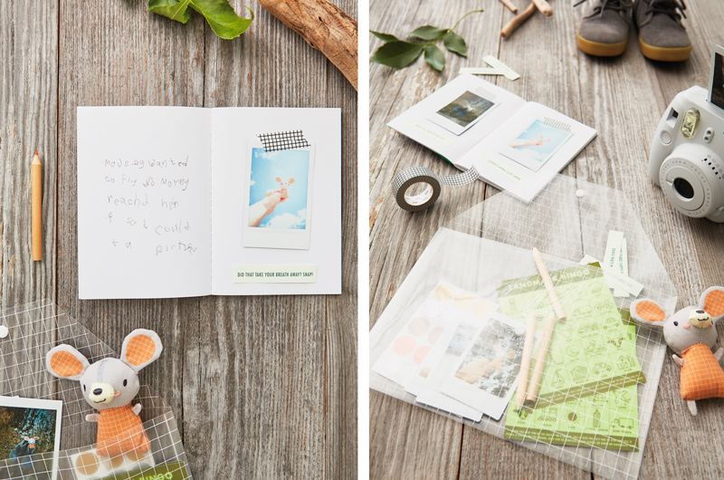 A travel journal with instant photos taped inside, with a packet of other travel games nearby.