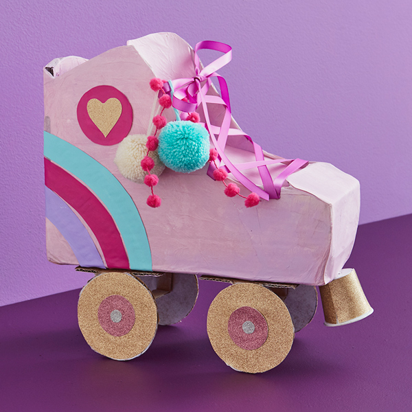 A valentine box shaped like a roller skate, decorated with pom-poms and glittery wheels.