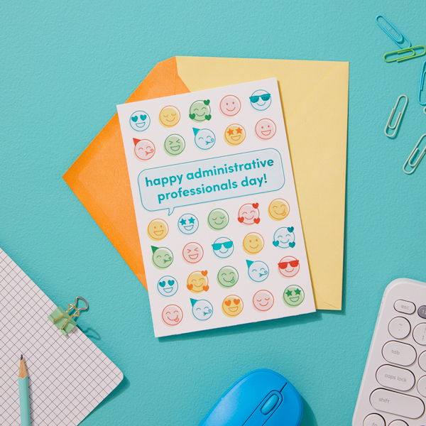 A card featuring a variety of happy emoji faces, with a speech bubble that reads,
