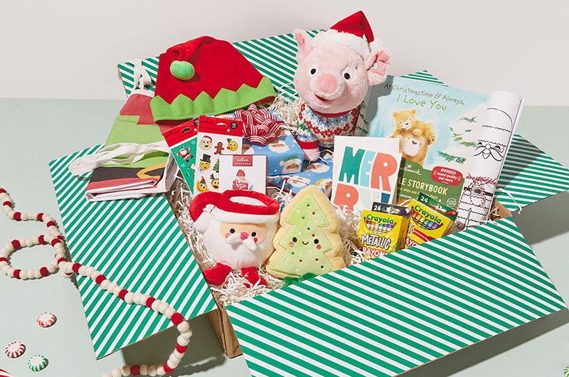 A Christmas care package for kids featuring an interactive, singing pig plush, a