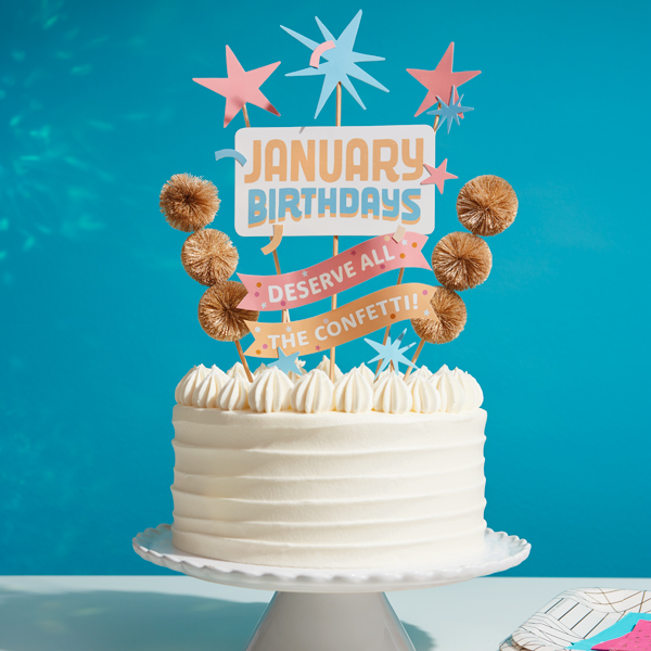 A birthday cake with a topper that says,