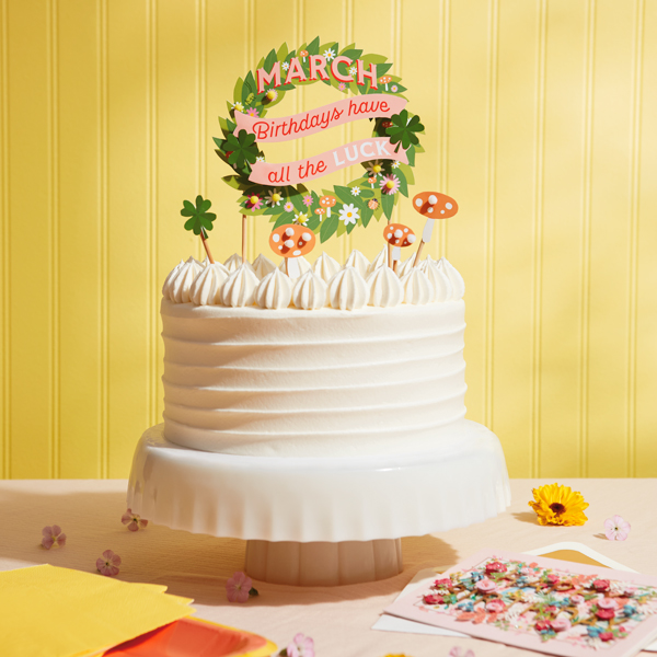 A birthday cake with a topper that says,