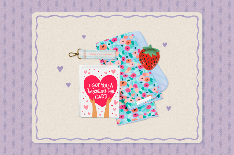 A collection of Valentine's Day gifts for a coworker that includes a strawberry-shaped trinket dish, a greeting card that reads,