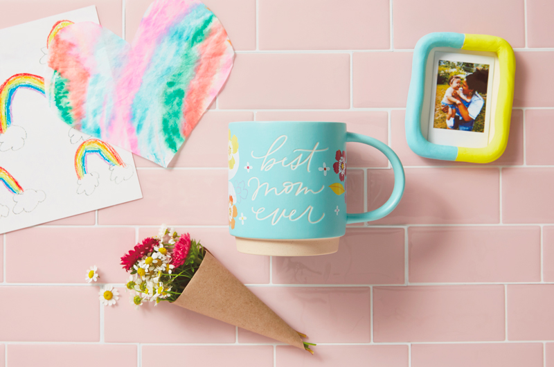 A mug gift bundle meant for a mom that includes a light blue ceramic mug that reads,